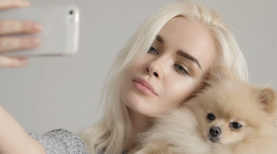 Pet Influencer taking selfie with pomeranian dog